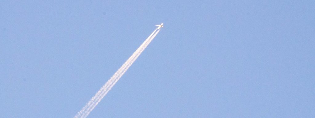 airplane flying over mount parnitha, greece