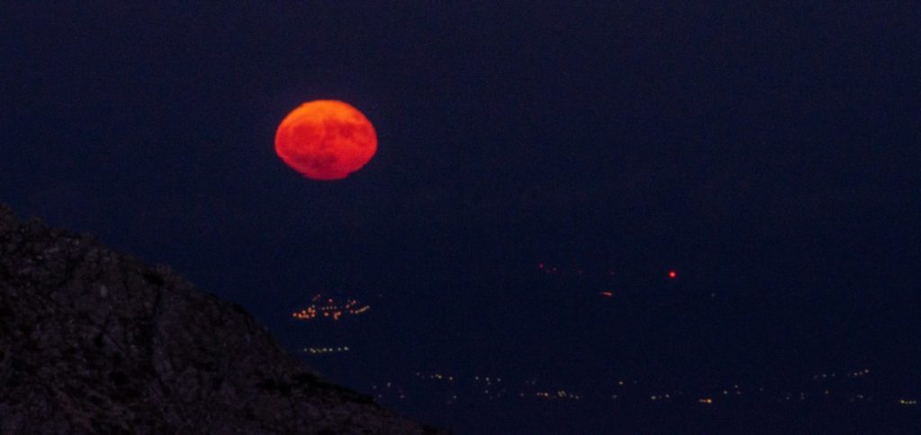 moon rising over athens from mount parnitha