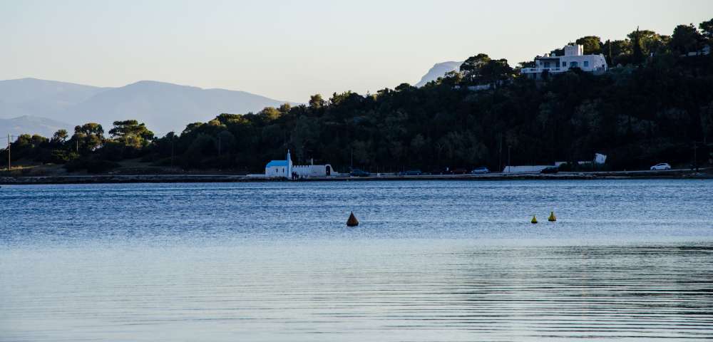 church across lake vouliagmenis