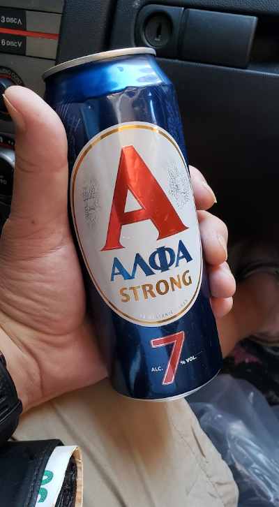 can of alfa strong beer in athens, greece while sitting in car