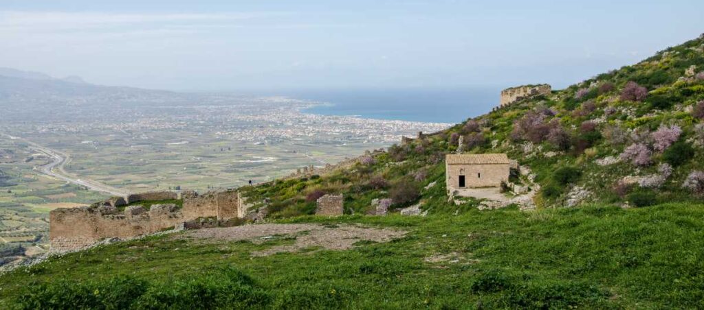 walls and buildings inside acrocorinth with a view of Corinthian Gulf