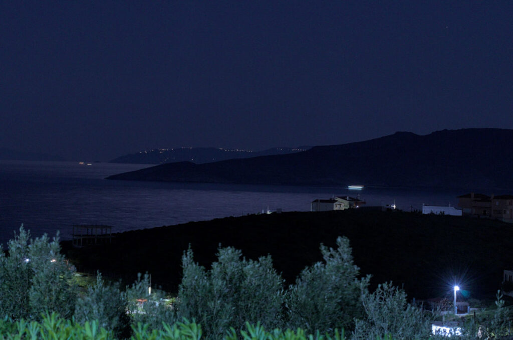 almost full moon shining on makronisos with shutter speed of 5 seconds