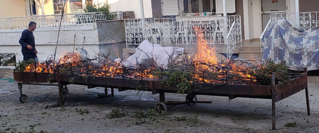 getting the barbeque ready to roast lamb in exharchos