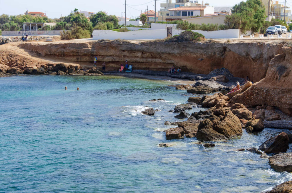 small inlet where swimmers and sunbathers are enjoying