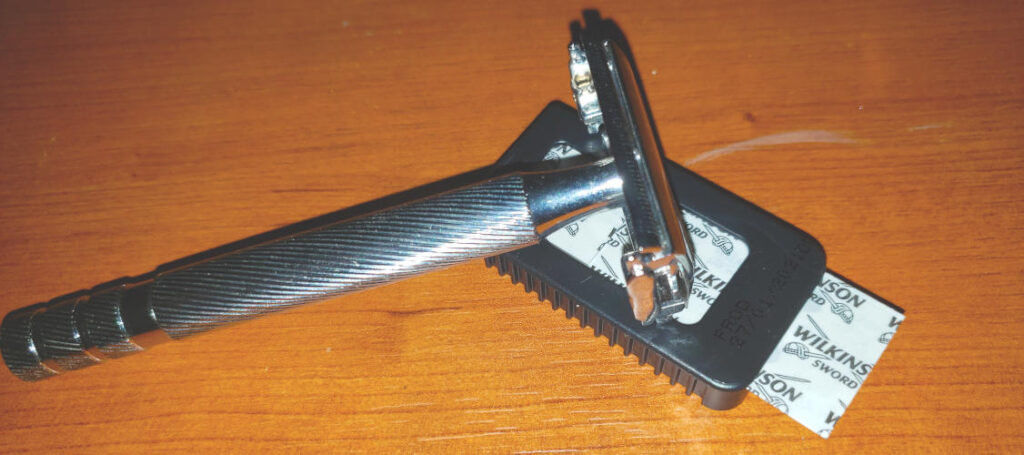 wilkinson sword razor and blades sitting on a wood surface